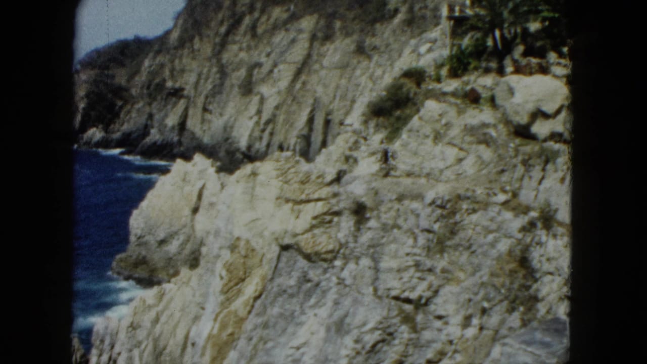 Acapulco-area coastal cliffs and Pacific ocean, figure at far right edge, 8mm home movie circa 1962
