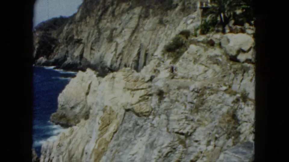 Acapulco-area coastal cliffs and Pacific ocean, figure at far right edge, 8mm home movie circa 1962