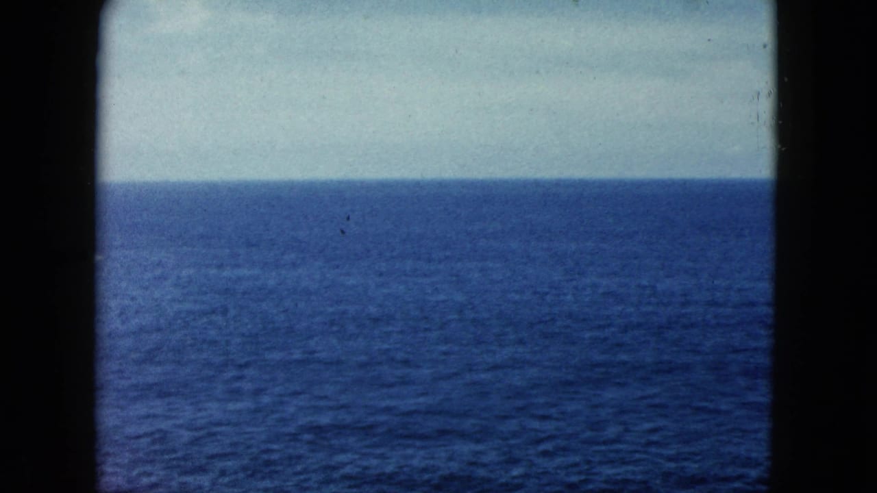8mm film frame circa 1962 showing the open Pacific Ocean under an overcast sky, likely filmed near Acapulco, Mexico.