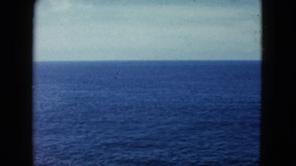 8mm film frame circa 1962 showing the open Pacific Ocean under an overcast sky, likely filmed near Acapulco, Mexico.
