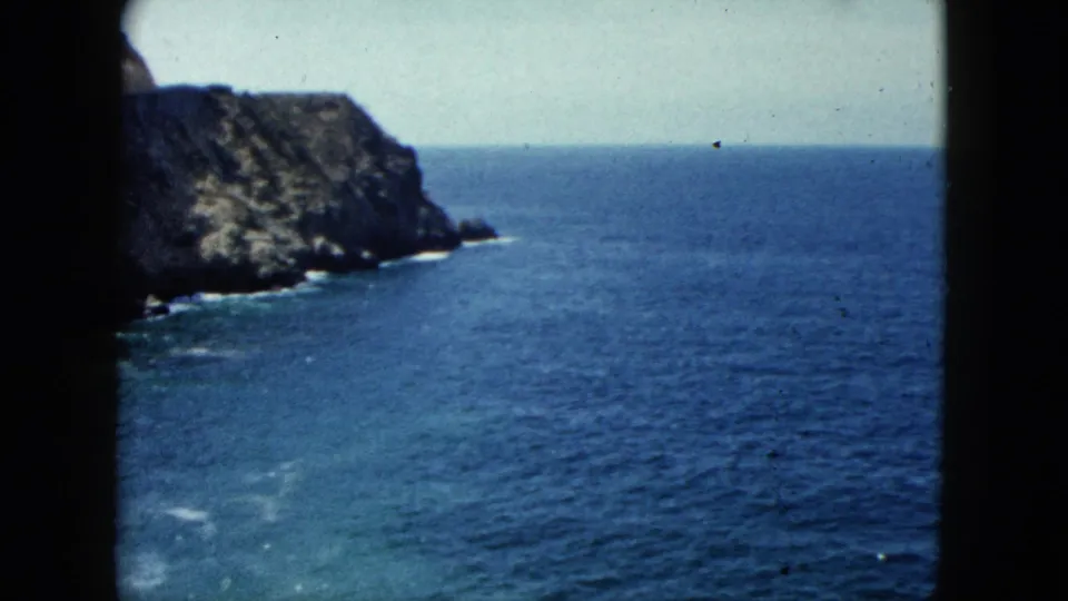 8mm footage circa 1962 showing a steep rocky cliff alongside the Pacific coast, possibly along the Acapulco coastline, Mexico.