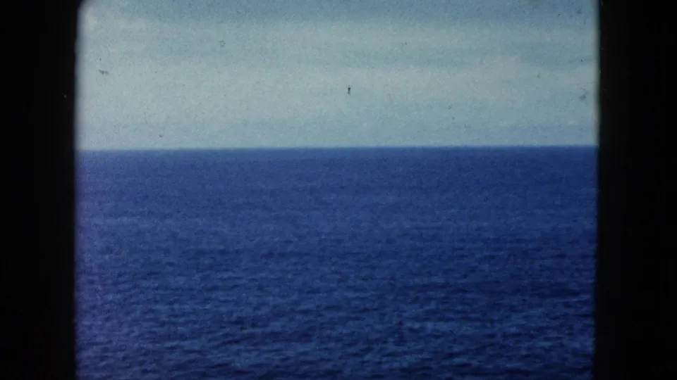1962 Acapulco home-movie frame focused on open Pacific water and a level horizon, with the dark 8mm frame edge visible at the sides.