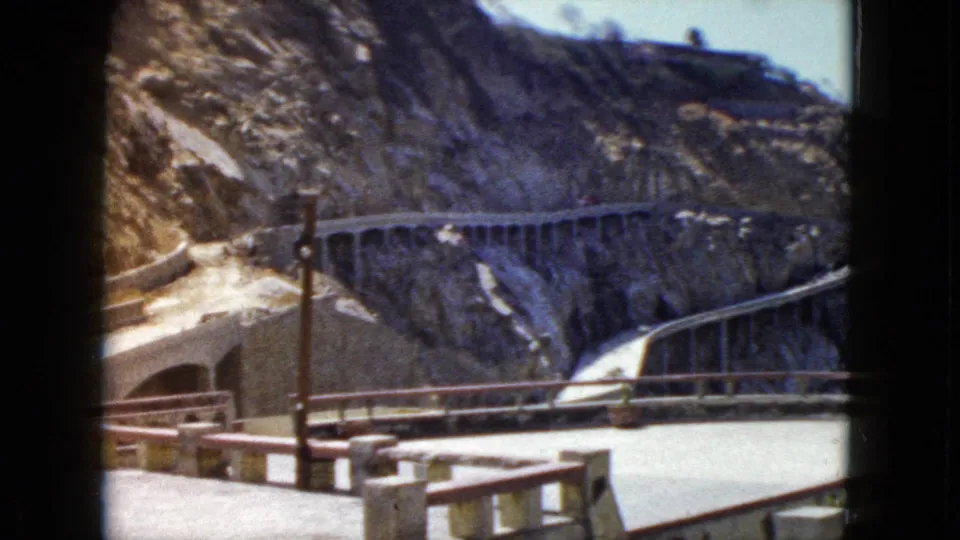 Cliffside road winding along barren rocky mountain with concrete balustrade in the foreground, Acapulco, Mexico, circa 1962