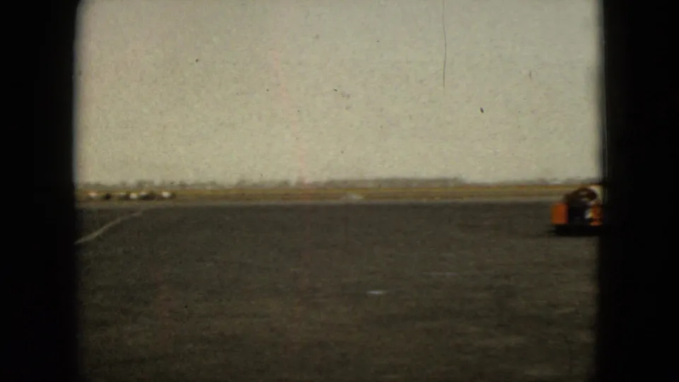 The 1962 Acapulco airport view shows open tarmac, runway markings, distant low structures, and equipment near frame right.