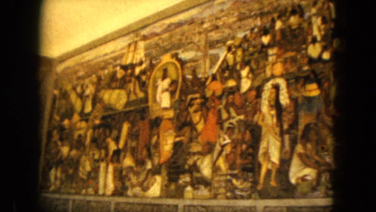 1962 Acapulco footage holds on the mural, showing clustered painted figures, earth tones, and handheld 8mm framing.