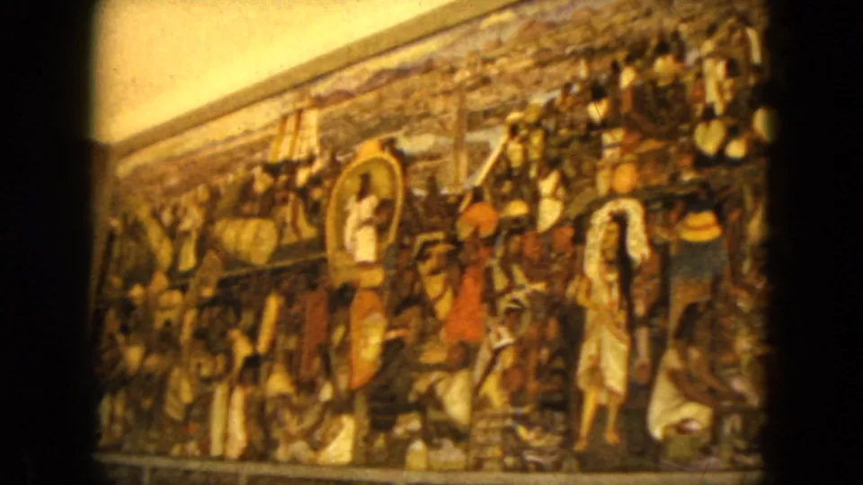 Final 1962 Acapulco frame showing the religious painting off-center, with a central white figure, surrounding figures, and strong film grain.