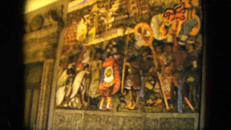 Final 1962 Acapulco frame holds on the dense mural scene, showing painted figures, staffs, shield-like shapes, and aged 8mm color.