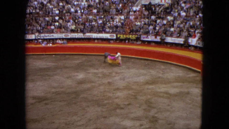 The final frame shows the matador and bull low in the sandy Acapulco ring, with the bright cape spread near them.