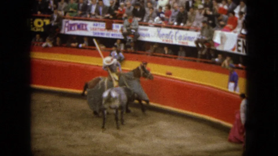 A mounted fighter appears to lift a spear while the bull stands close in the 1962 Acapulco bullring scene.