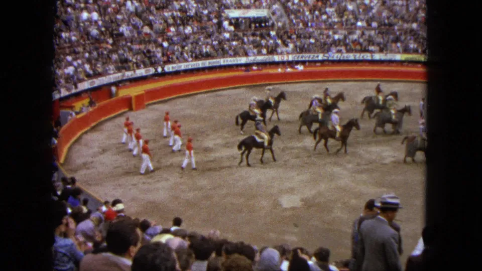 1962 Acapulco bullfighting-event procession with riders on horseback and red-and-white performers in formation.