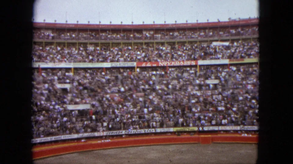 A wide 1962 Acapulco arena view shows spectators packed into curved stands above the ring edge and visible signage.