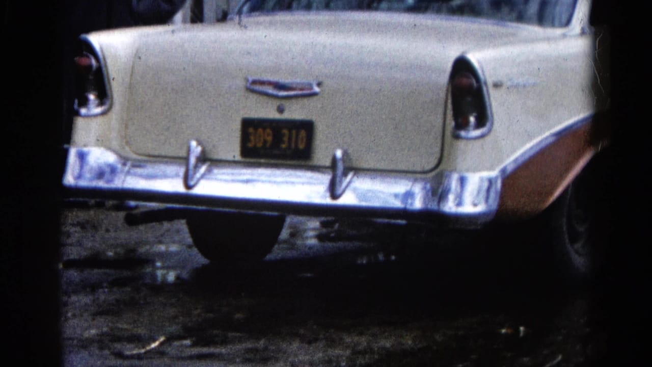 Rear view of a cream-and-brown classic Chevrolet in Wauconda, Illinois, with chrome bumper, tail fins, and a dark plate visible.