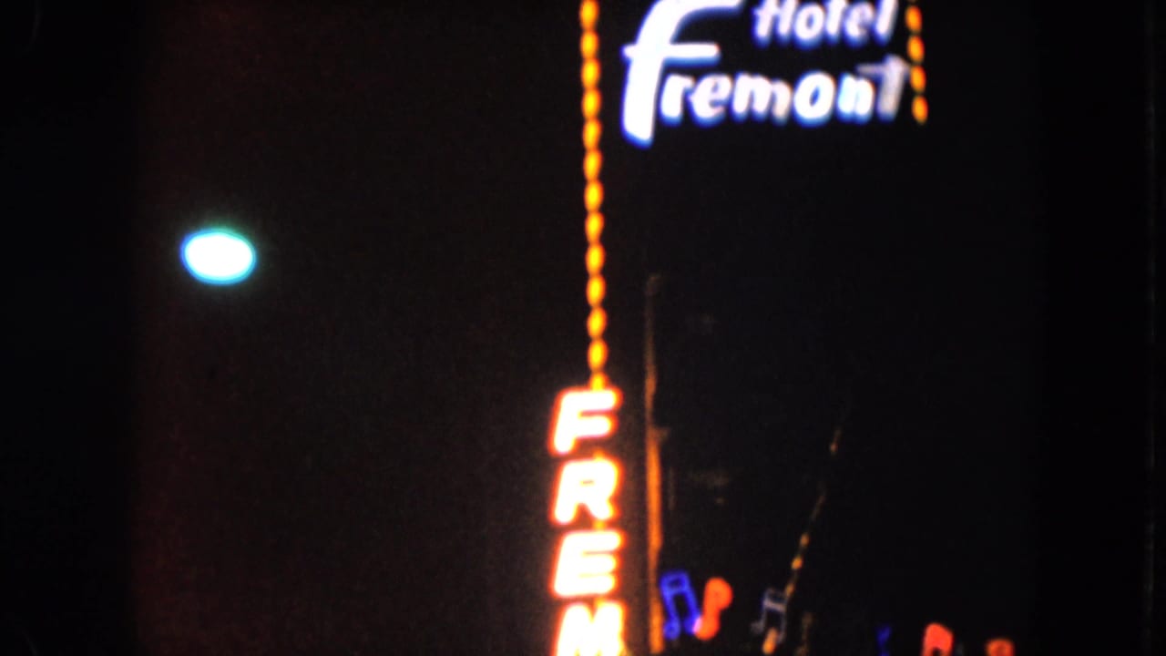 1961 Nevada night footage showing the Hotel Fremont neon sign and partial casino signage in a dark street scene.