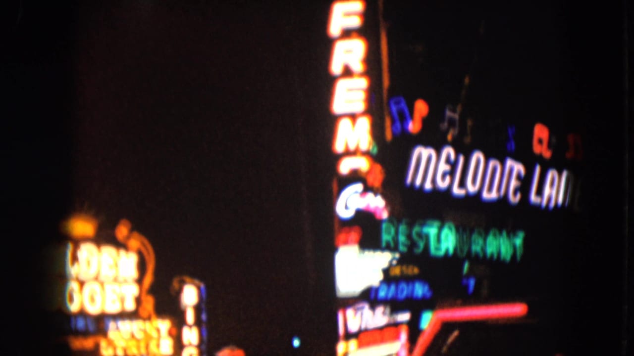 Bright Melodie Lounge and restaurant neon signs beside partial Golden Nugget lights.