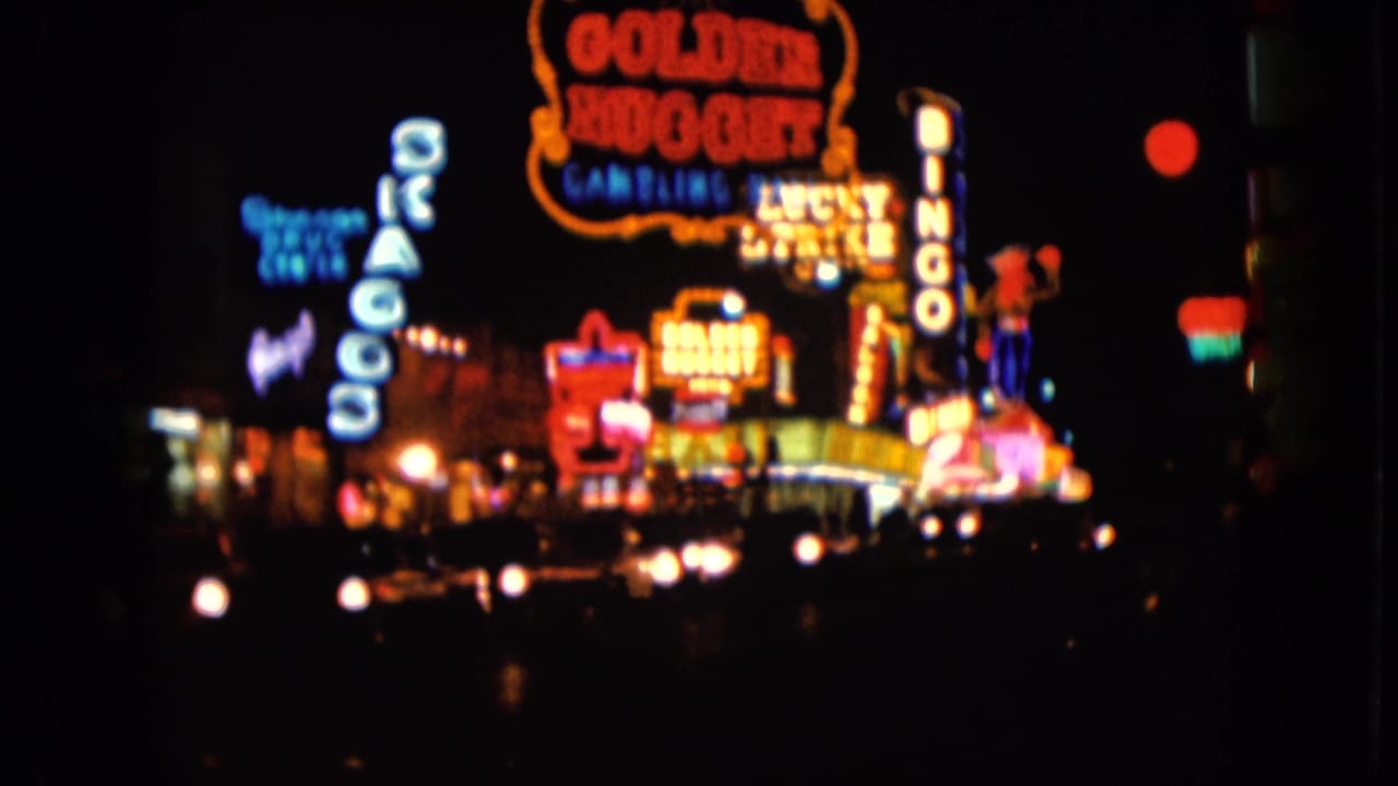 1961 Las Vegas night footage shows the Golden Nugget sign and nearby neon marquees from a soft, moving 8mm viewpoint.