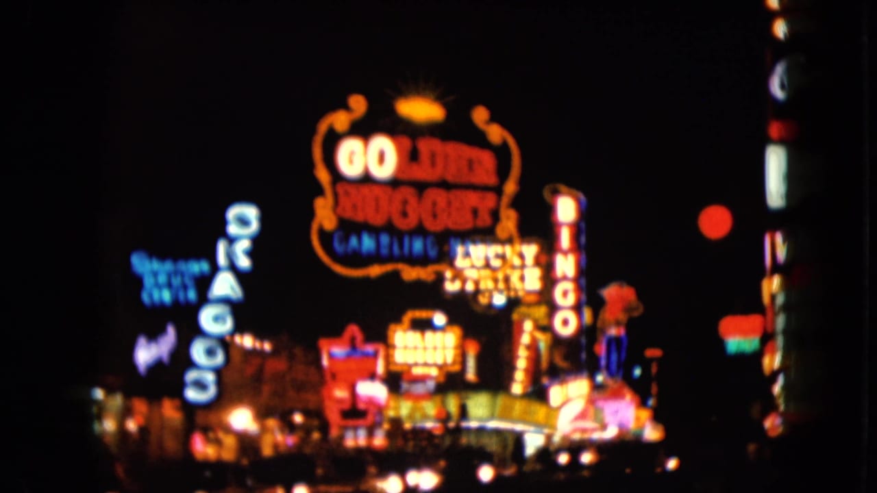 Blurred Las Vegas neon signs with Golden Nugget and Bingo lettering at night.
