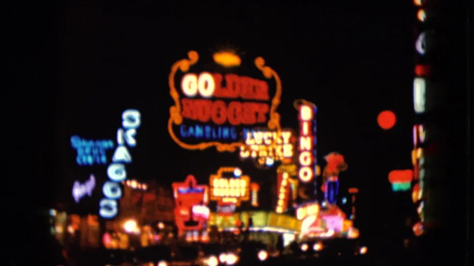 The frame shows Golden Nugget and Bingo neon signage in the Las Vegas night scene, softened by motion and small-gauge film exposure.