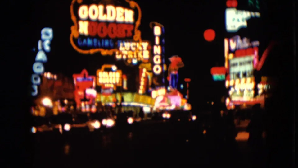 The final frame keeps the Golden Nugget and Bingo signs in view, with layered Las Vegas neon and passing street lights in 8mm color.