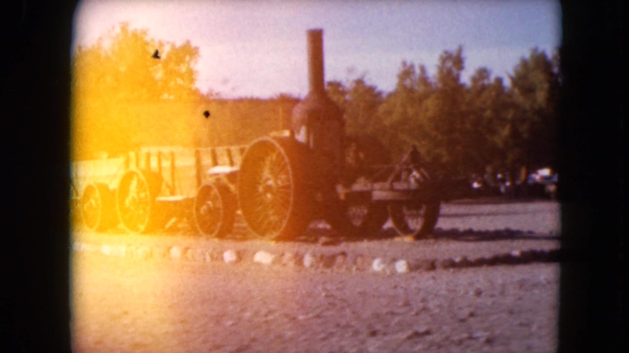 Antique steam traction engine in a Nevada outdoor display, partially washed by orange 8mm exposure flare.