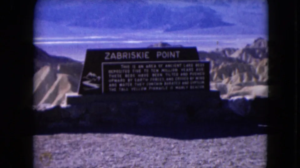 Final 1961 8mm frame holds on the Zabriskie Point sign with visible color shift and badlands in the background.