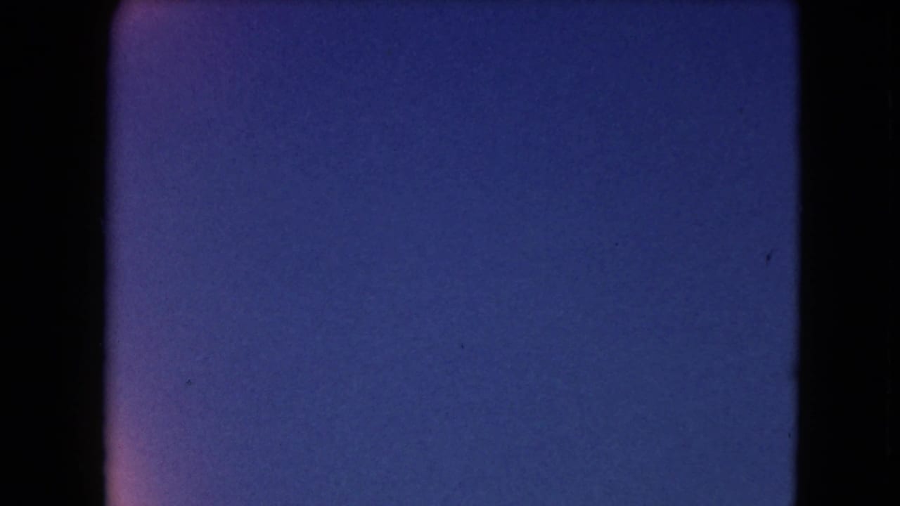 Dark blue film frame with black borders and slight color variation.