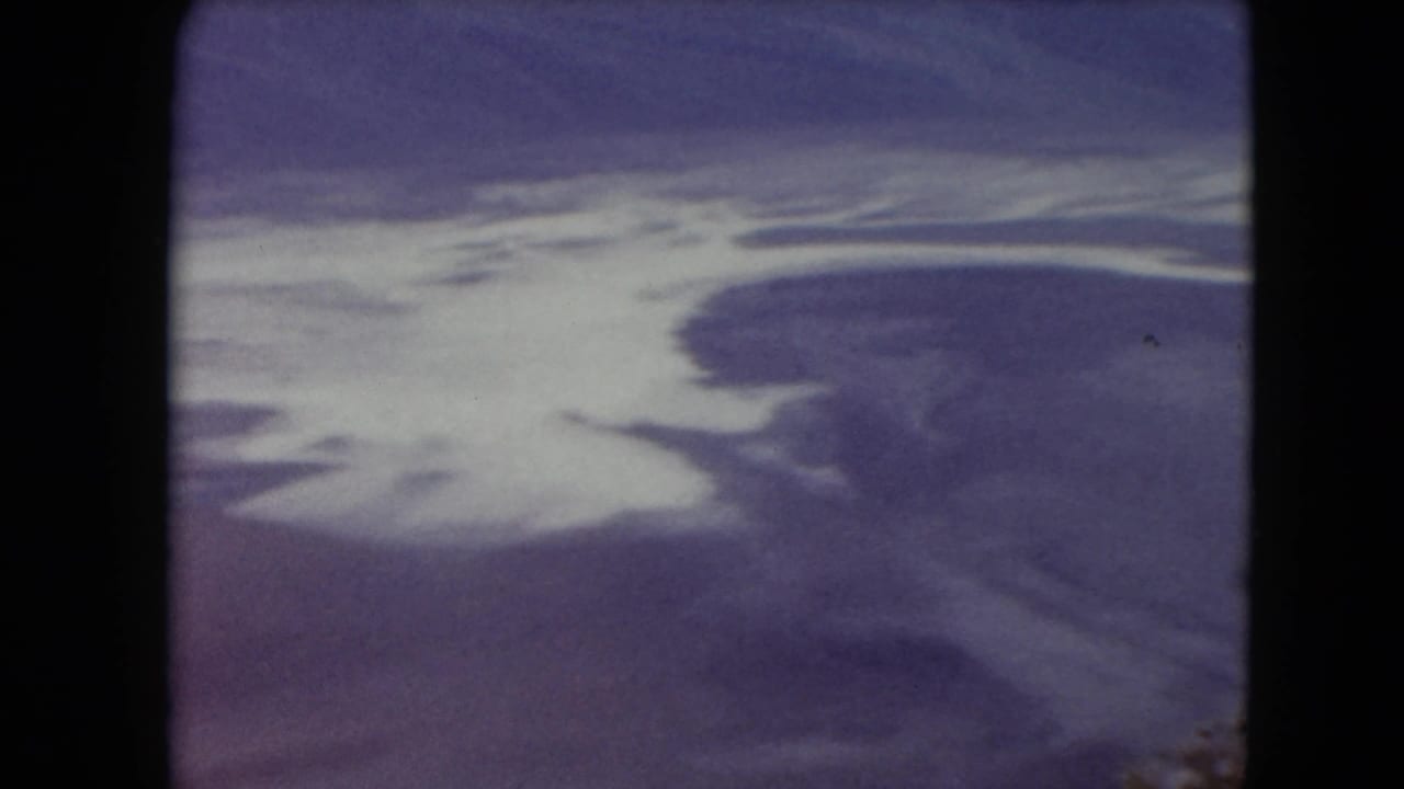 1961 Nevada 8mm frame with branching pale water or mineral areas crossing a muted desert surface from above.