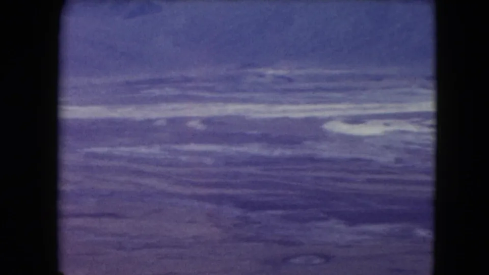1961 Nevada 8mm frame showing a broad desert mountain view beneath a pale sky, with strong film borders visible.