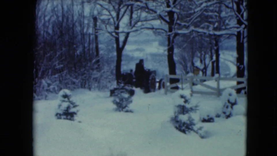 Final frame shows the tractor near the white fence in the snowy 1961 rural Wisconsin setting.