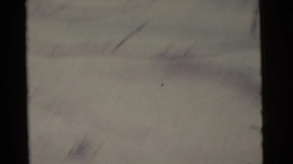 1961 Camden 8mm frame showing pale snow, subtle track marks, dark frame edges, and very soft focus with no identifiable person visible.