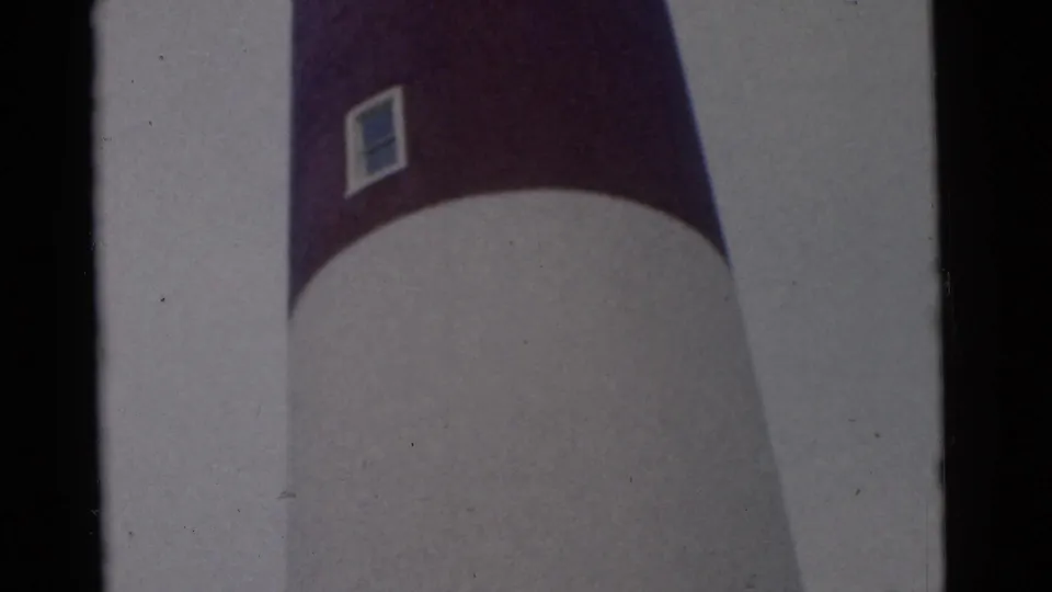 1961 Camden 8mm frame showing the white tower or lighthouse with a purple band and small square window near the top.