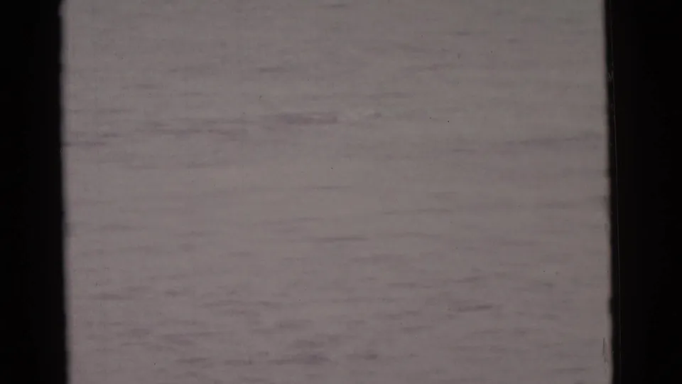 The final 1961 Camden home-movie frame shows open water and faint surface texture with the diver no longer clearly visible.