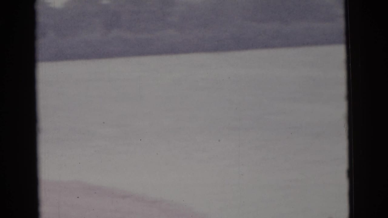 1961 Camden-area home-movie frame showing a soft-focus expanse of water with a faint distant bank.