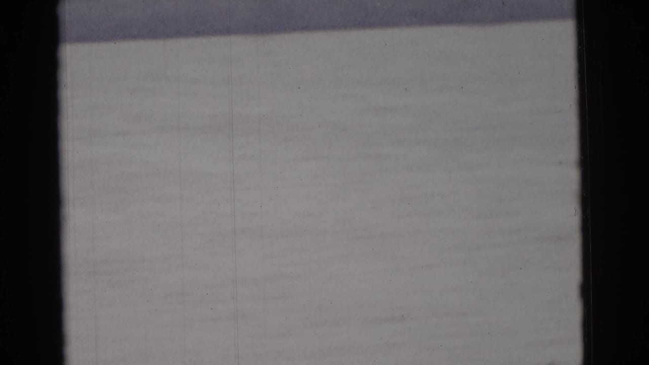 Soft 8mm frame from the supplied Camden 1961 clip, showing mostly water and dark scan borders.
