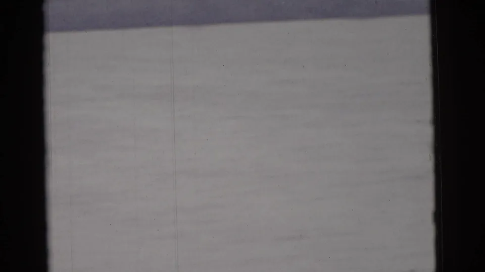 Soft 8mm frame from the supplied Camden 1961 clip, showing mostly water and dark scan borders.