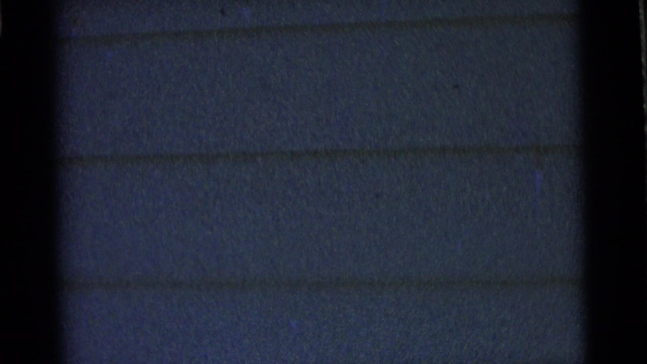 Dark, soft view of exterior house siding with little visible activity.