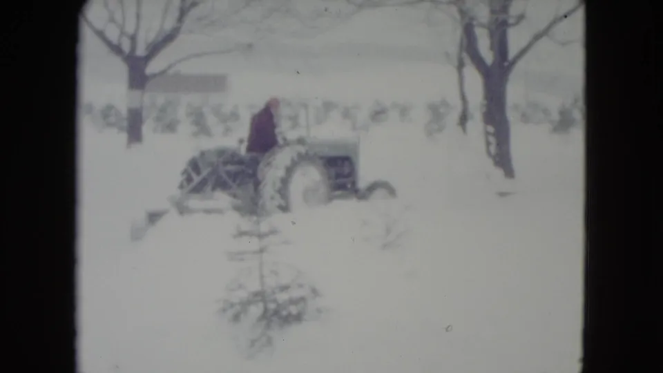 A side view shows the tractor and blade pushing snow in the 1960 Madison, Wisconsin winter scene.