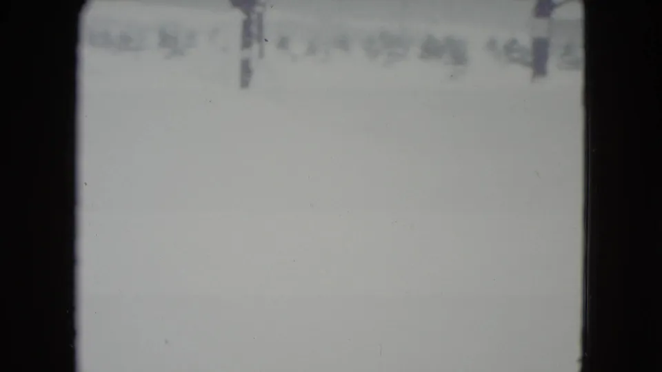 1960 Madison, Wisconsin winter landscape with a washed-out snow field and faint distant trees or utility poles.