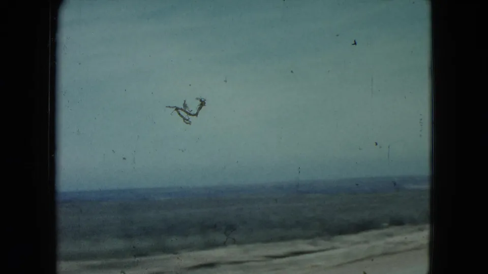 1960 Nevada driving view across sparse countryside, with a low horizon and road edge visible under a pale sky.
