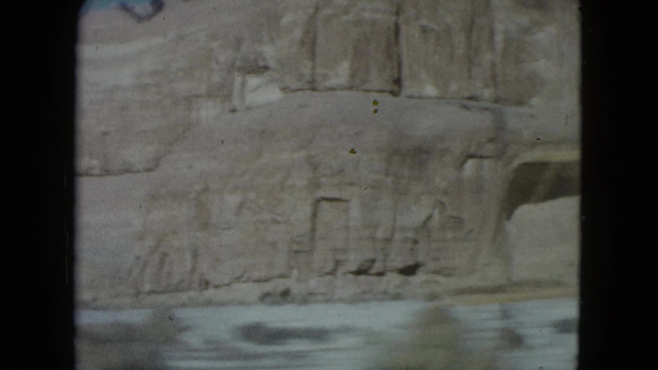 Faded 1960 Nevada road-trip frame with a rocky wall and blurred road surface at the bottom.