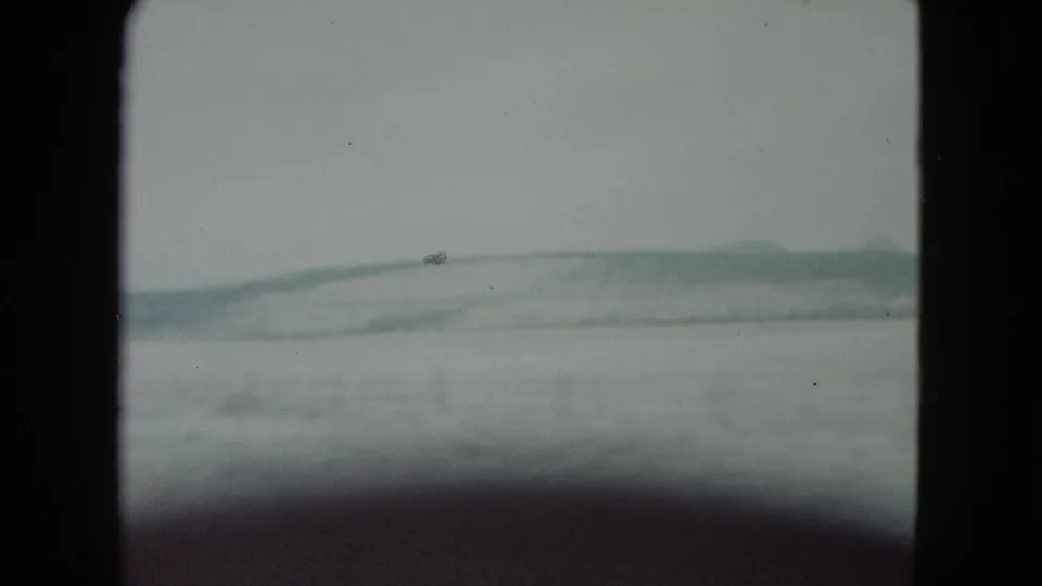 1960 Nevada road-trip view of pale snowy hills framed by the dark edges of the 8mm film gate.