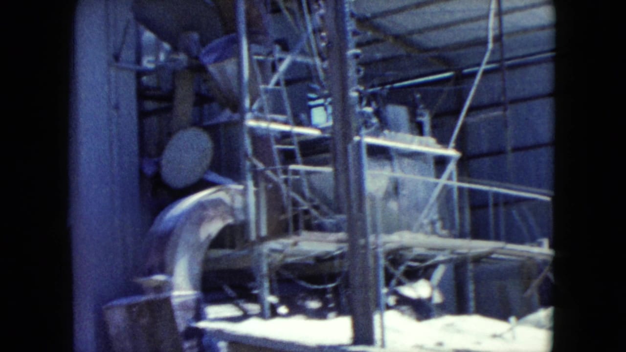 1960 Nevada factory frame with scaffolding, curved metal ducting, and large industrial equipment, with no clear logos visible.