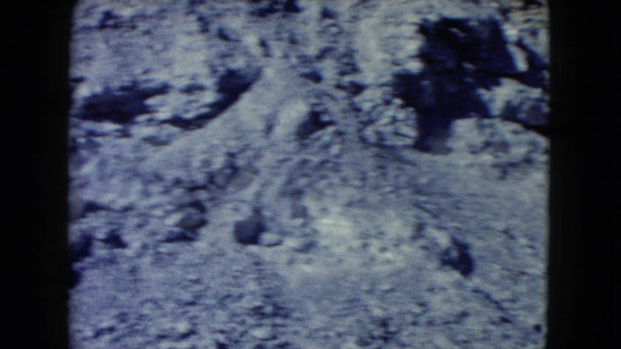 Close-up of rough desert rocks and eroded pale ground.