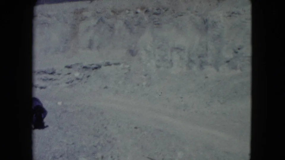 The final frame holds on barren Nevada desert terrain, with only a partial person visible near the edge.