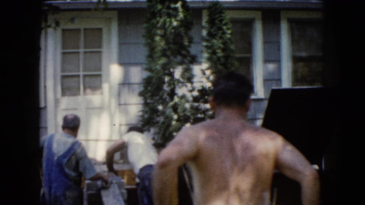 In Wauconda, Illinois, 1960, several men work outdoors beside a house during a backyard construction task.