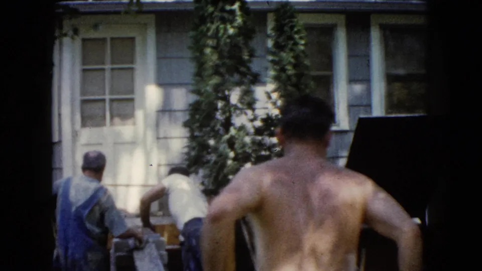 In Wauconda, Illinois, 1960, several men work outdoors beside a house during a backyard construction task.