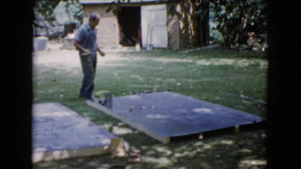 At the end of the clip, the man stands beside the concrete slab and supply can in the Wauconda backyard setting.