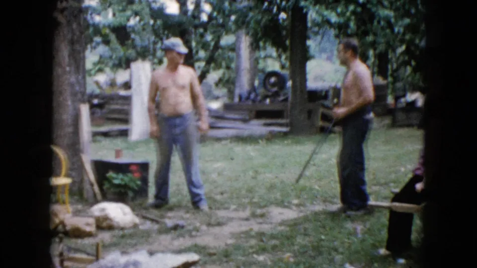 At the end of the 1960 Wauconda clip, the man with the long gun stands farther right while the other remains near the tree.