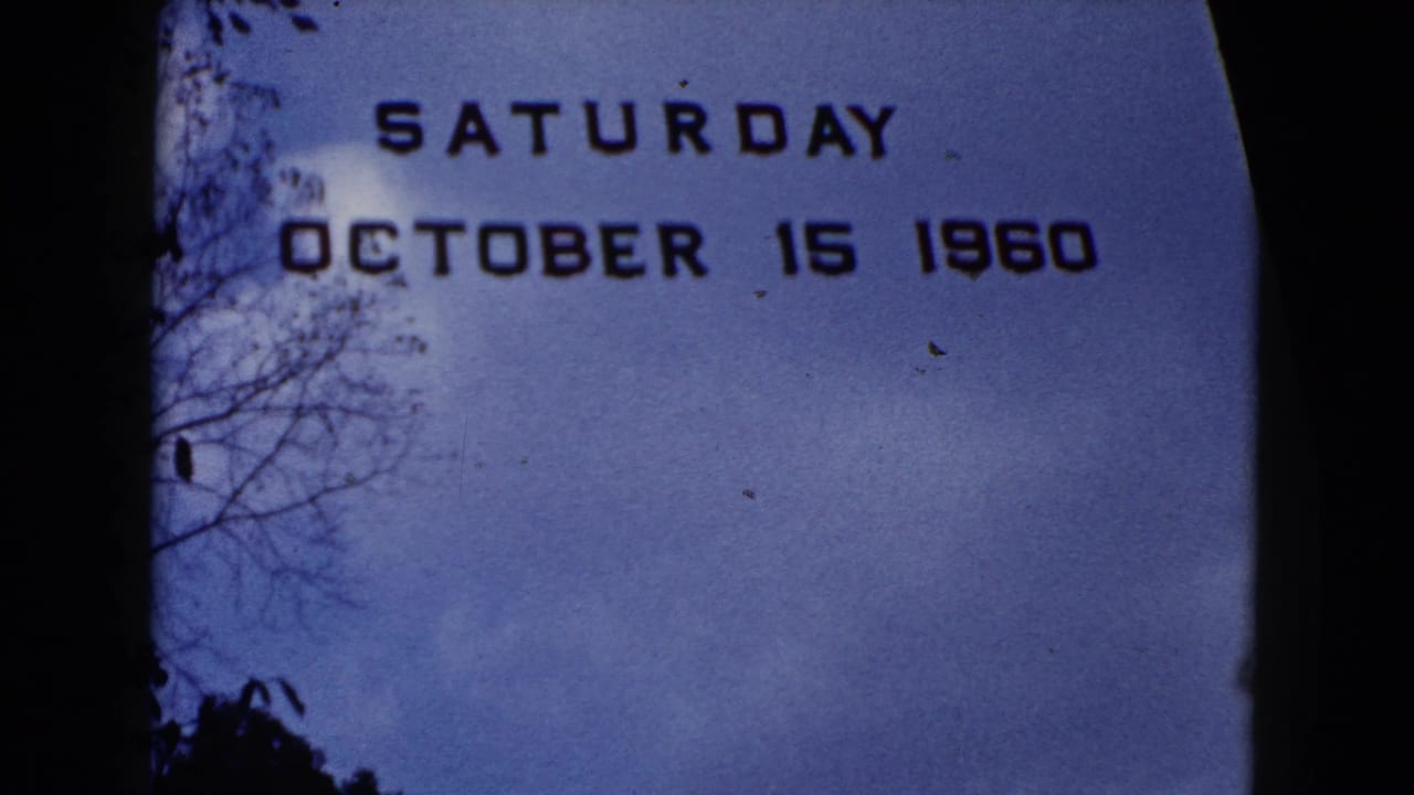 Date title over blue sky, with tree branches at left and dark rounded frame borders.