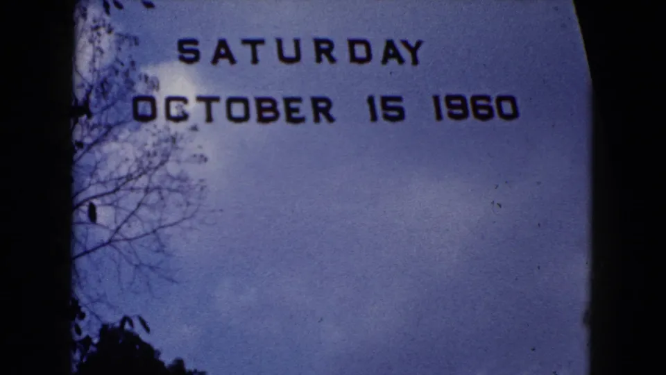 Final 1960 Wauconda title frame with Saturday October 15 1960 text, tree silhouettes, blue sky, film grain, and rounded 8mm borders.