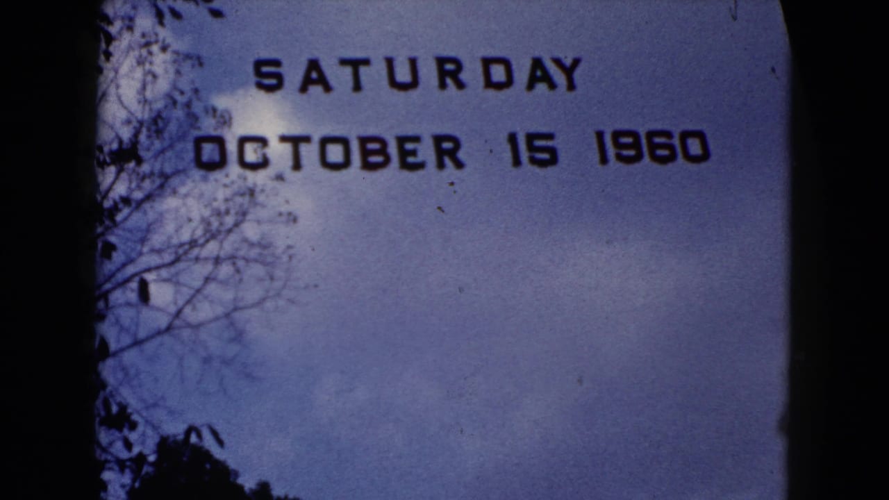 Dated 1960 title card remains on screen, with sky, tree branches, and dark film borders visible.